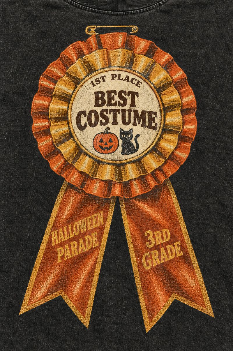 Washed black tee printed with an orange and gold prize ribbon rosette reading 1st Place, Best Costume, with tails reading Halloween Parade and 3rd Grade