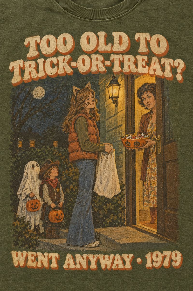 Moss green tee printed with a teenage girl in cat ears and a puffy vest holding a pillowcase at a neighbor’s door while the neighbor raises an eyebrow, words Too Old to Trick-or-Treat? Went Anyway, 1979